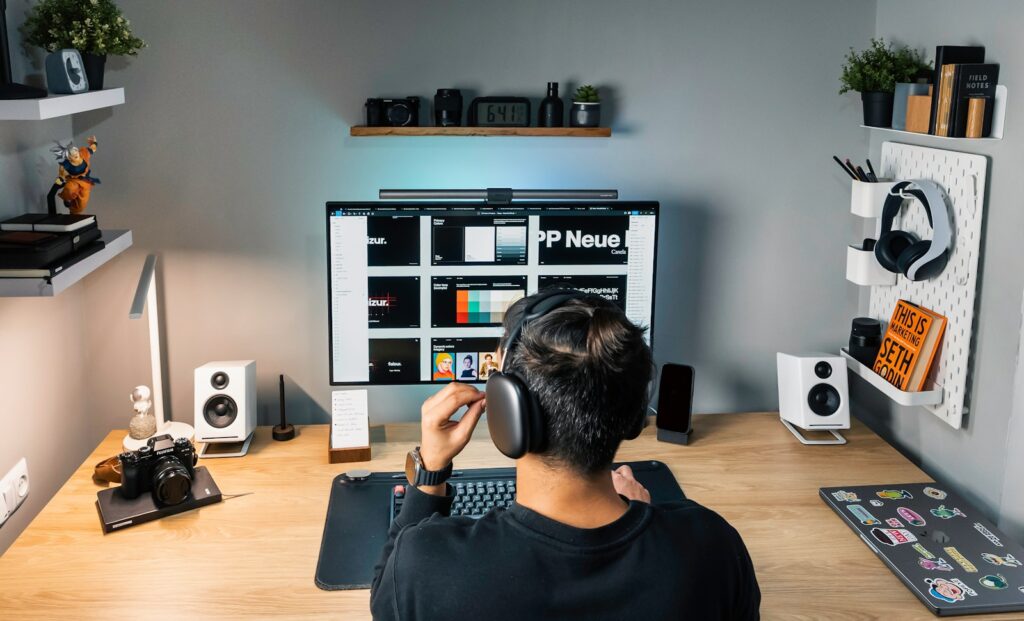 a man sitting at a desk with headphones on