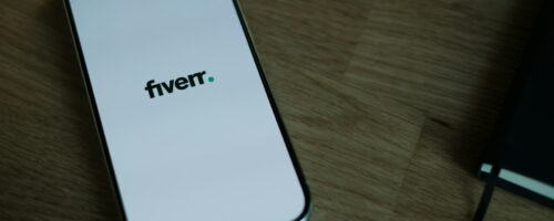 A cell phone sitting on top of a wooden table